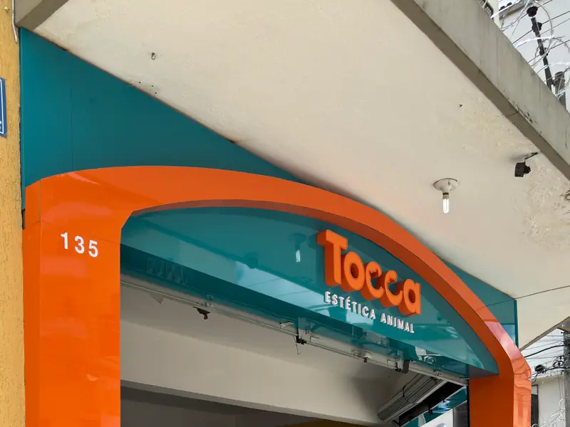 Fachada em ACM laranja e turquesa da Tocca Estética Animal